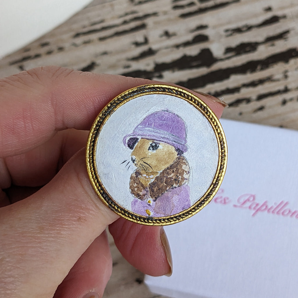 painting of a Hare wearing a hat. Brooch