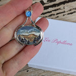 Load image into Gallery viewer, painting of the Sperrins from the Gortin Glens. Set onto a necklace. painted jewellery
