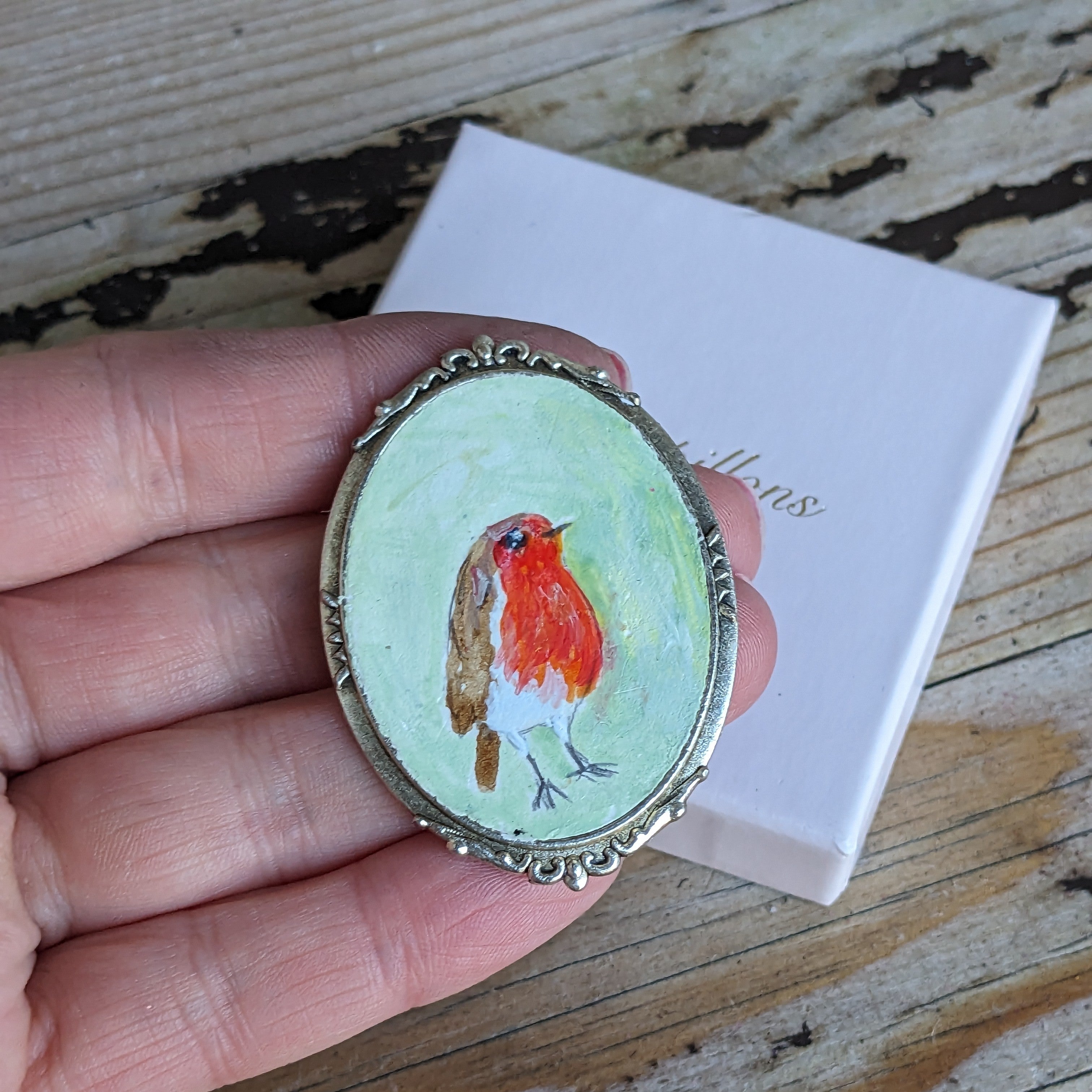 Messenger of sollace, a painted robin brooch