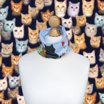Load image into Gallery viewer, neck snug with cats in a garden
